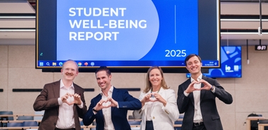 A group of four professionals presenting a student well-being report at IE University.