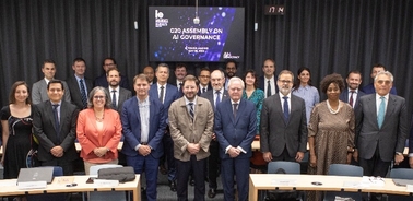 A group of professionals standing in front of a presentation screen in a conference room.