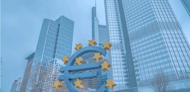A giant euro sign monument in front of modern skyscrapers in a city.