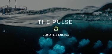 An atmospheric view of underwater bubbles with a ship in the background.