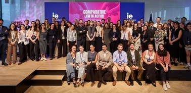 A large group of people posing together in a professional setting.