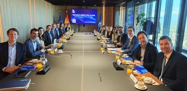 A group of people gathered around a conference table in a modern office setting.