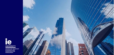 A view of modern skyscrapers with reflective glass facades under a clear blue sky.