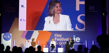 A panel discussion at the Hay Festival in Segovia featuring speakers on stage.