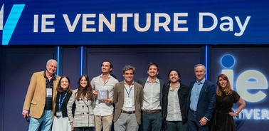 A group of people celebrating at an IE Venture Day event.