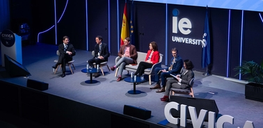 A panel discussion taking place at an event hosted by IE University.