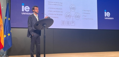 A man presenting a slide on network of green deal data at a university event.