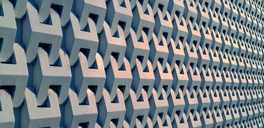 A geometric pattern of interlocking shapes on a wall.