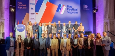 A group of people standing on a stage at the Hay Festival Segovia, with a large '17' sign and multiple logos in the background.