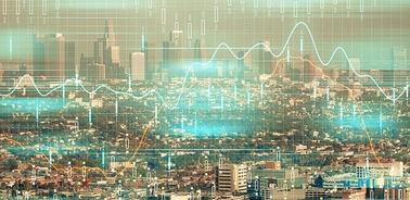 A digital representation of a city skyline overlaid with data graphs and analytics.