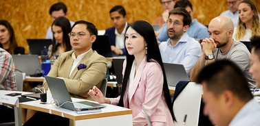 A diverse group of professionals attentively participating in a seminar.