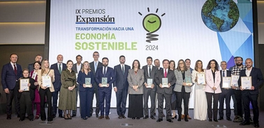 A group of people posing with awards at a sustainable economy event in 2024.