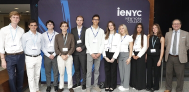 A group of young people standing in front of a banner for iENYC New York College.