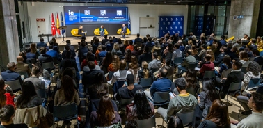 A large audience attending a conference at IE University.