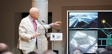 An architect presents a design proposal using visual aids on a screen.