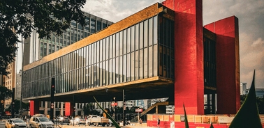 This is a modern architectural structure featuring large glass windows and bold red accents.