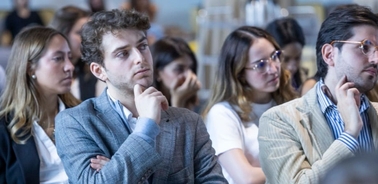 A group of people attentively listening during a seminar or conference.