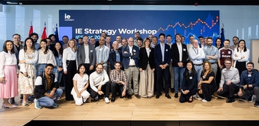 A group of people posing together at the IE Strategy Workshop event.