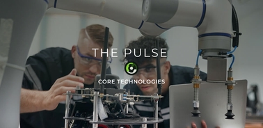 Two engineers are inspecting a robotic system in a technology laboratory.