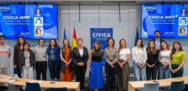 A group of people posing together for a photo at a public lecture event.