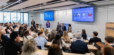A panel discussion taking place in a modern conference room with an audience engaged.
