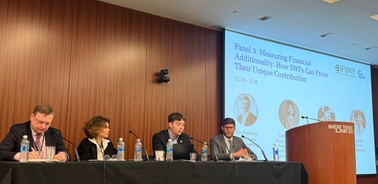 A panel discussion on measuring financial additionality with four speakers at a conference.