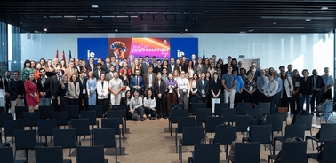 A large group of people gathered in an indoor setting for a conference or event.
