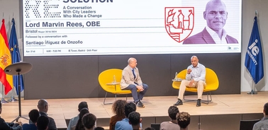 A conversation event featuring Lord Marvin Rees and Santiago Iñiguez de Onzoño on stage.