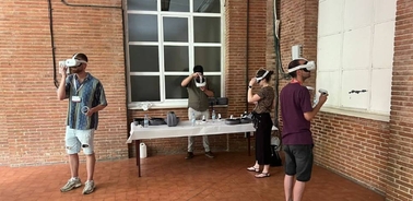 A group of people experiencing virtual reality in a spacious setting.