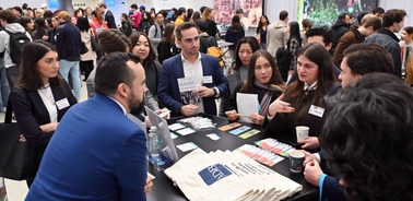 A group of people engaged in conversation at a networking event.