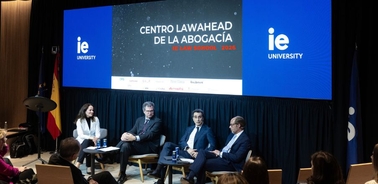 A panel discussion at IE University featuring multiple speakers.