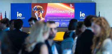 A conference event at IE University featuring a banner on law and automation.