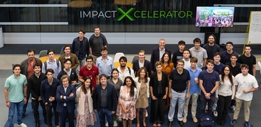 A large group of people posing together in an indoor setting for a photo.