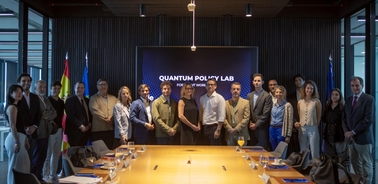 A group of professionals gathered at the Quantum Policy Lab for a meeting.