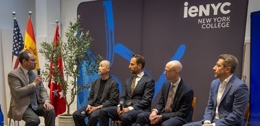 A panel discussion at iENYC New York College featuring several speakers.