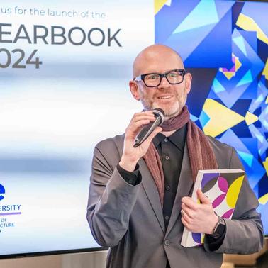 A man is speaking at the launch event for the Yearbook 2024 at IE University.