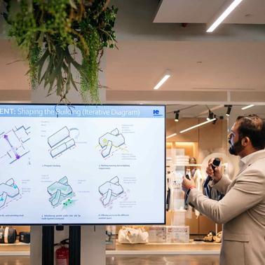 A professional presenting a developmental diagram in a modern setting.