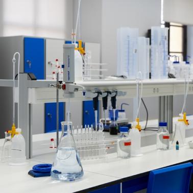 A modern laboratory workspace equipped with various glassware and lab instruments.