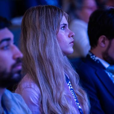 A focused audience member listens intently during an event.