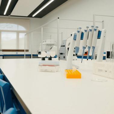 A modern laboratory with equipment and white surfaces.