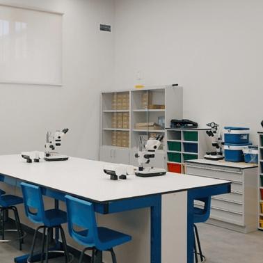 A modern classroom equipped with microscopes and colorful storage cabinets.