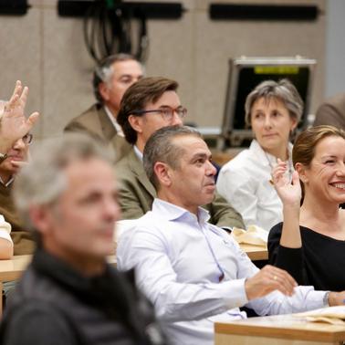 A group of people attentively participating in a discussion.