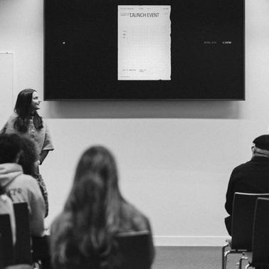 Two women are presenting at a launch event in front of an audience.