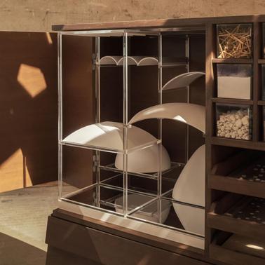 A modern shelving unit with clear compartments and white accents.