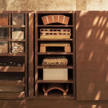 A display of various building materials arranged on shelves.