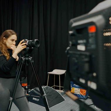 Woman with a professional camera in a film set
