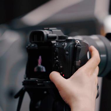 Hand holding a professional camera