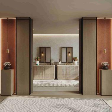 A stylish modern bathroom featuring dual vanities with mirrors, elegant wall sconces, and symmetrical decor.