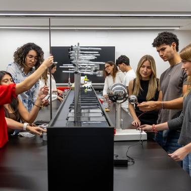A group of students engaged in a hands-on experiment in a science lab.