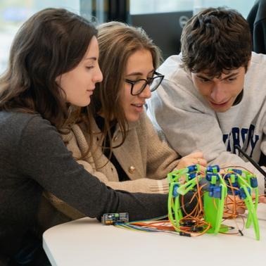 A group of students working together on a robotics project.